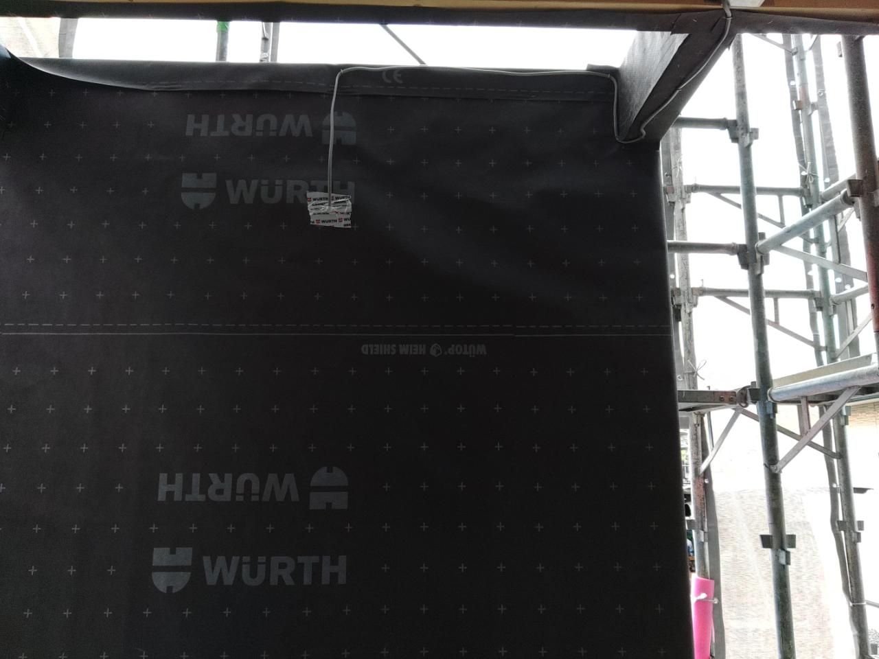 外部ポーチの化粧壁に配線工事が行われている様子です。